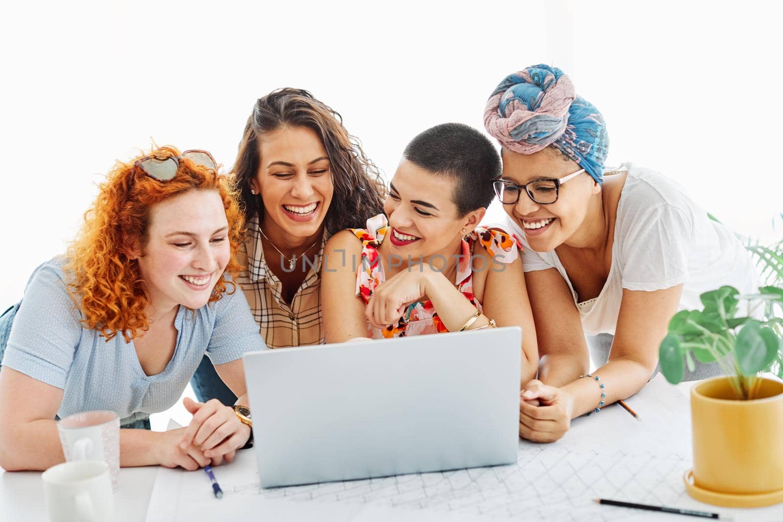 Happy young people friends with laptop in the office