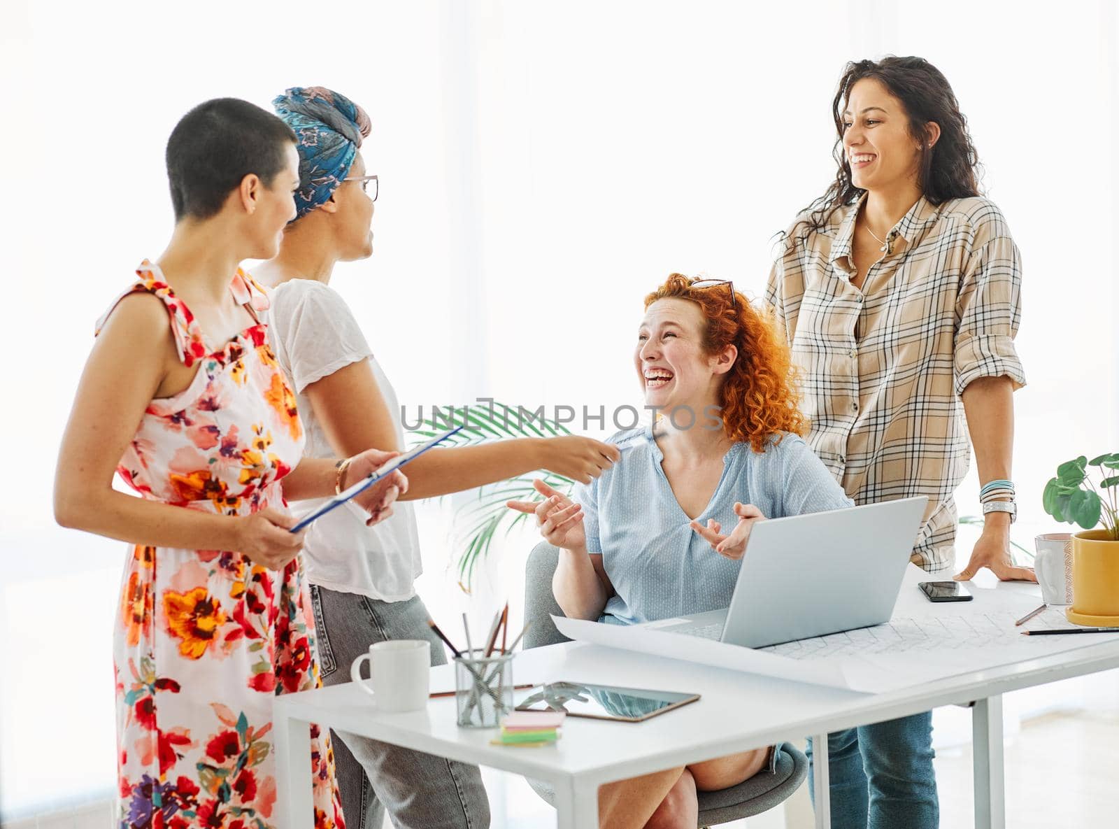 Happy young people friends with laptop in the office