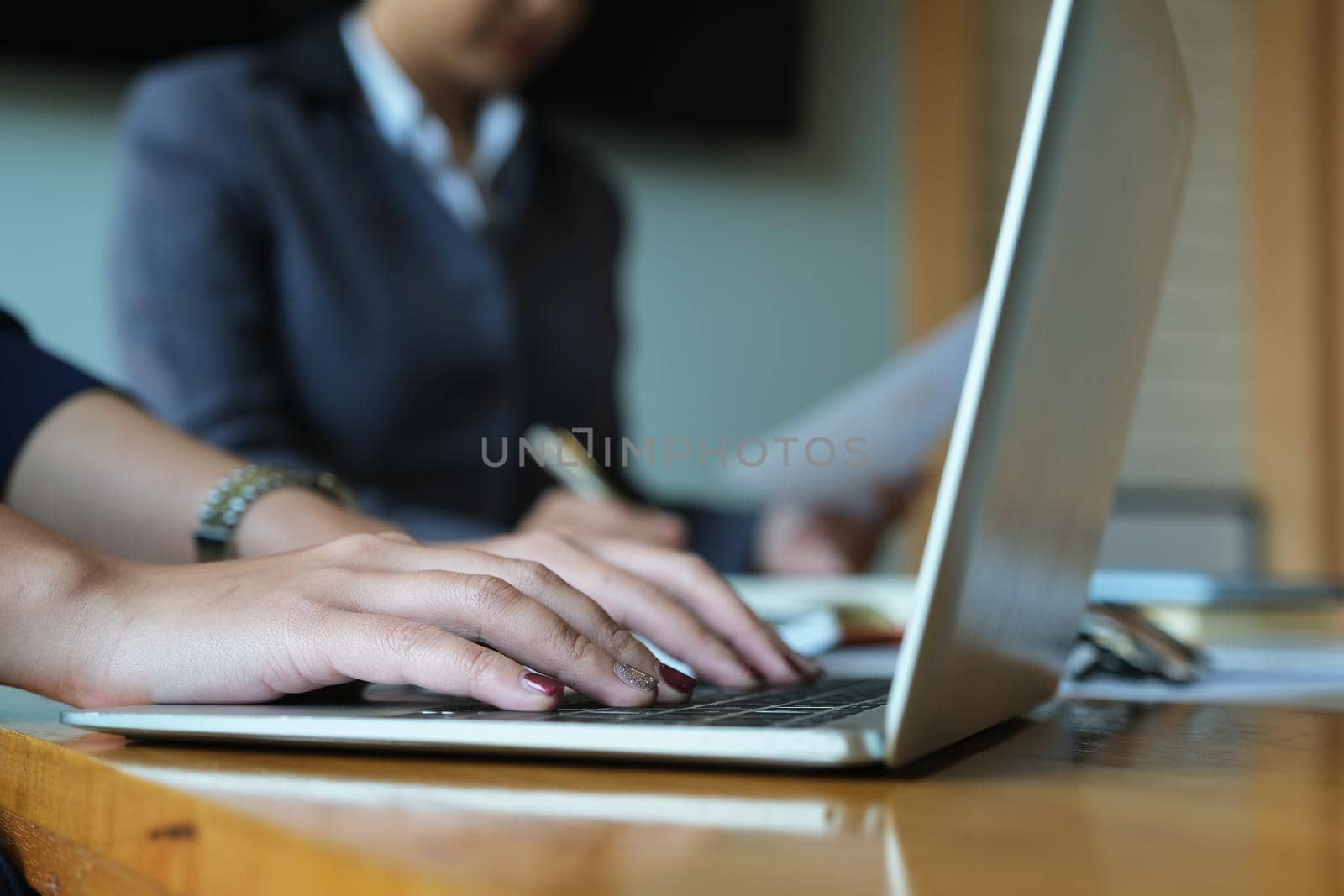 Company employees use computers to work on their work to calculate budgets and verify the correctness of their investments. by Manastrong