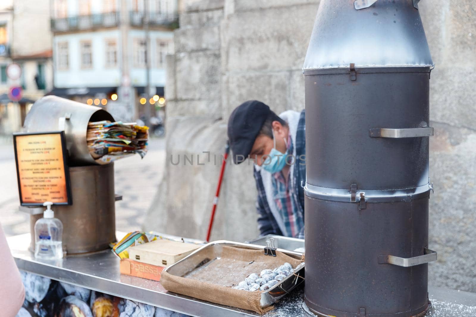 Street vendor of hot chestnuts cooked over charcoal in Porto, Portugal by AtlanticEUROSTOXX