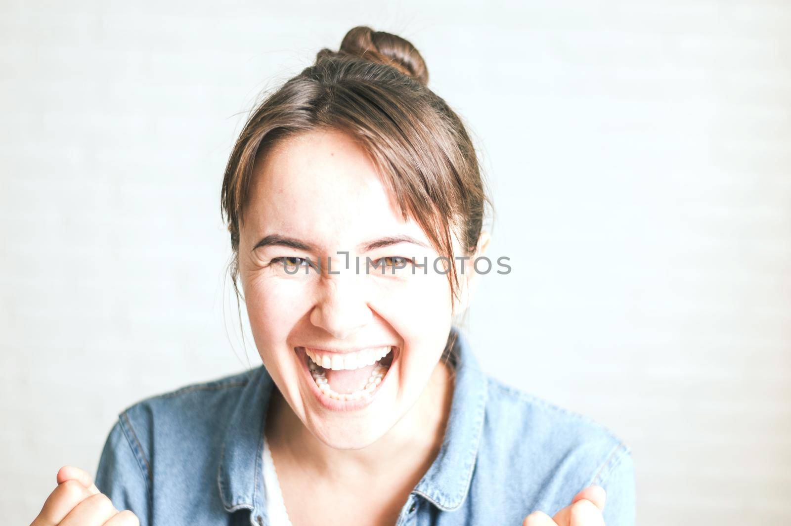 positive woman smiling on a light background by maramorosz