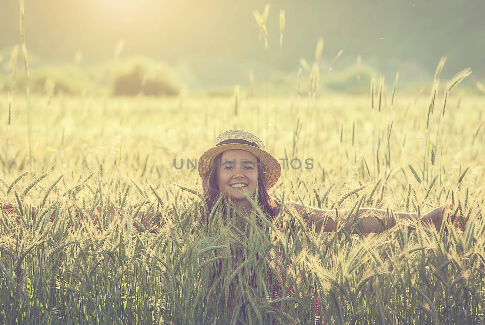 woman in wheat field by maramorosz