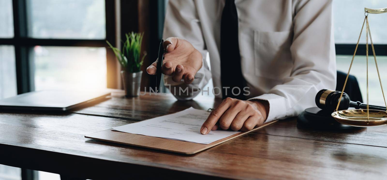 Close up business lawyer man reaching out sheet with contract agreement proposing to sign. individual who owns the business sign personally,director of the company, solicitor. by nateemee