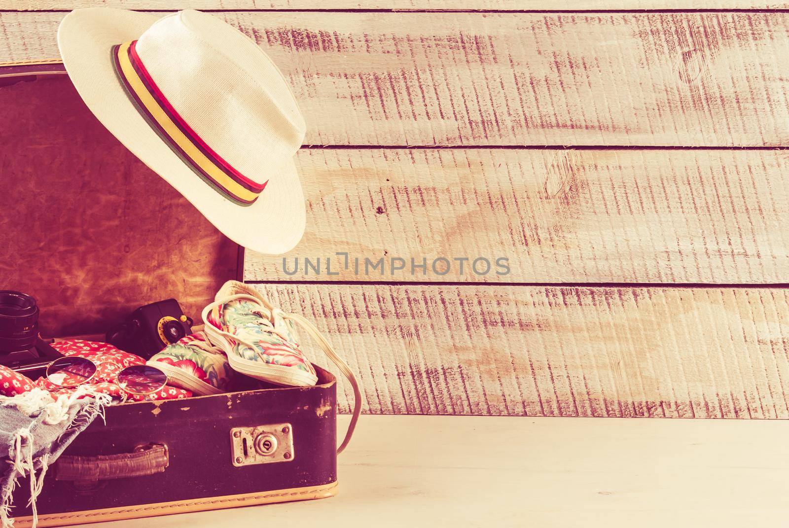 retro bag for summer vocation with photo camera, book and wicker hat by maramorosz