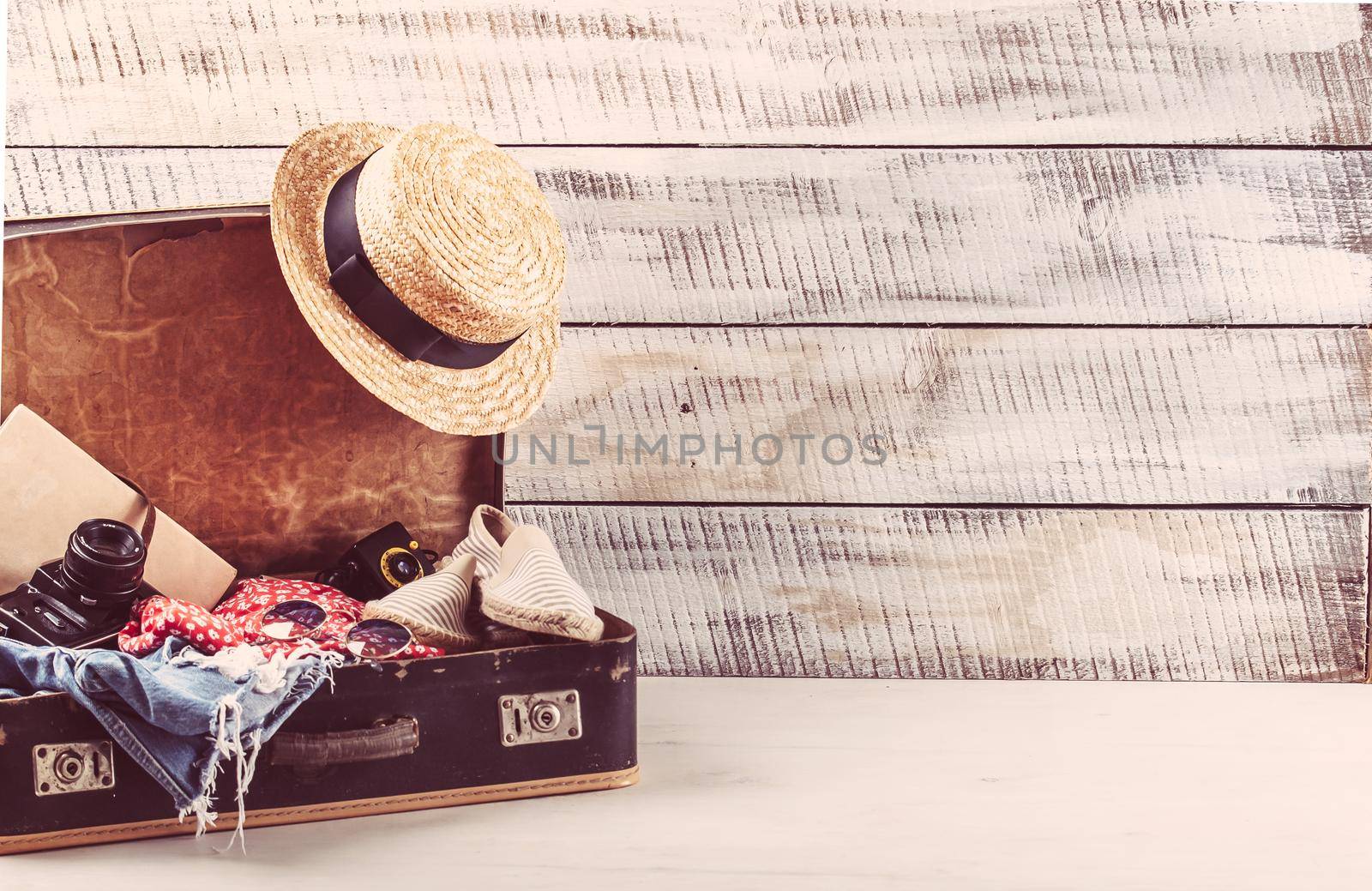 retro bag for summer vocation with photo camera, book and wicker hat. High quality photo