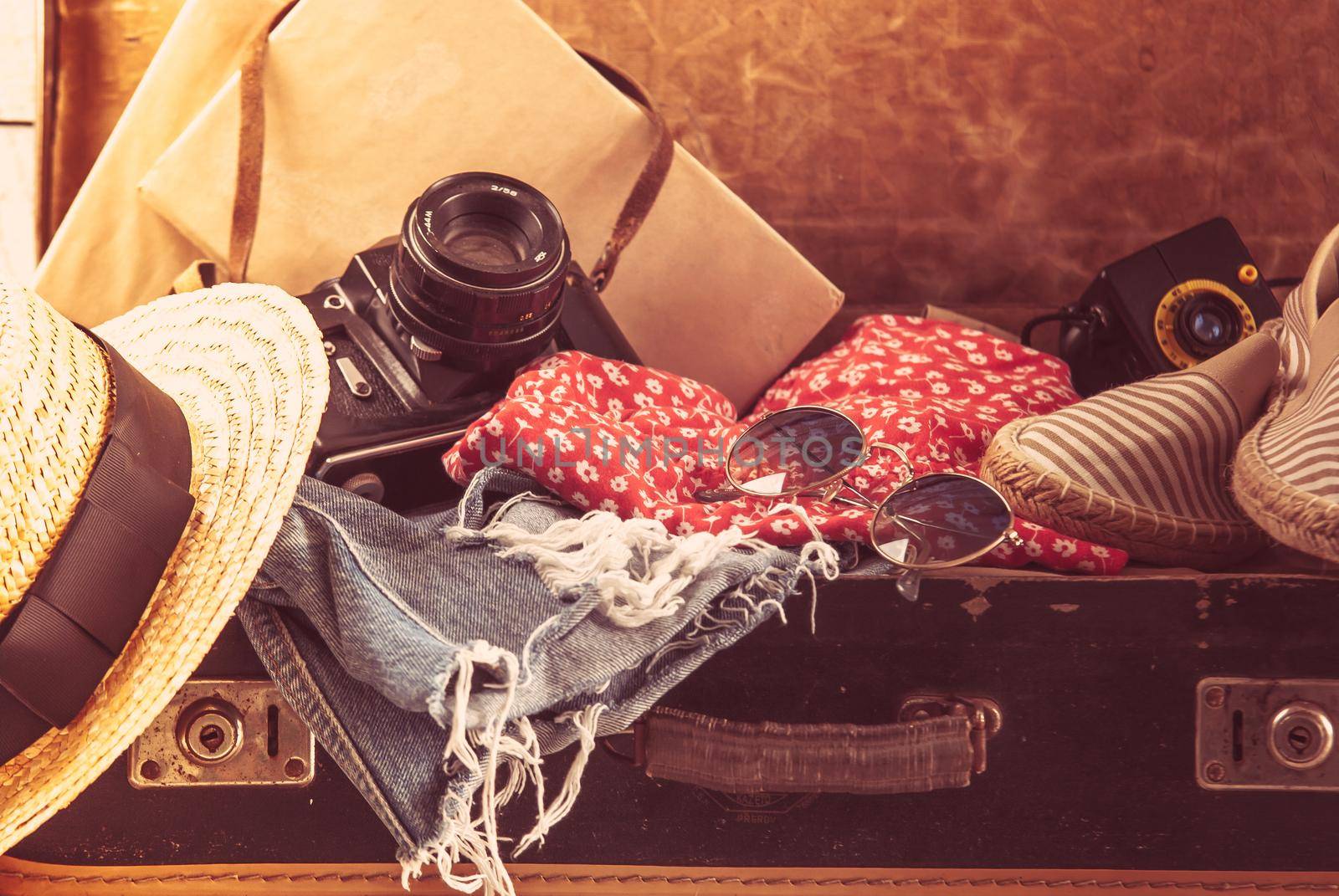 retro bag for summer vocation with photo camera, book and wicker hat by maramorosz