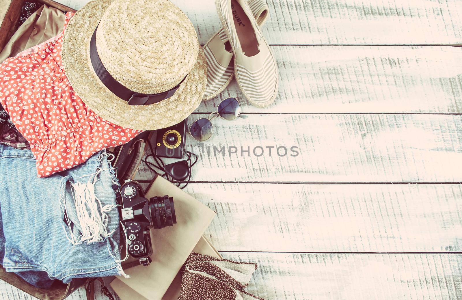 retro bag for summer vocation with photo camera, book and wicker hat. High quality photo