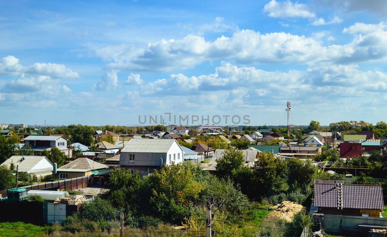 Country houses under expressive skies and white clouds