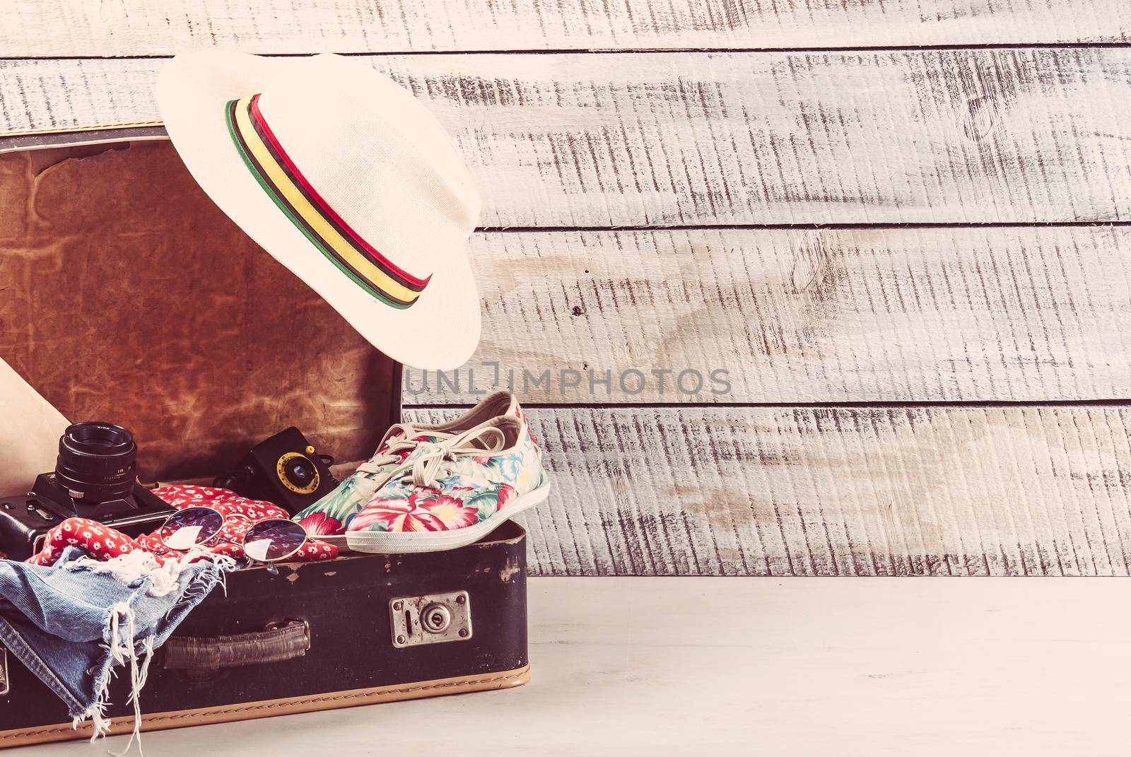 retro bag for summer vocation with photo camera, book and wicker hat. High quality photo