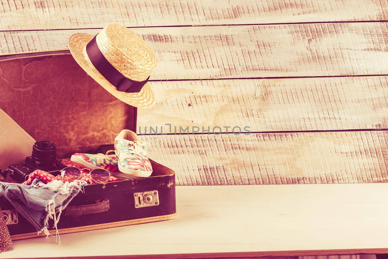 retro bag for summer vocation with photo camera, book and wicker hat by maramorosz