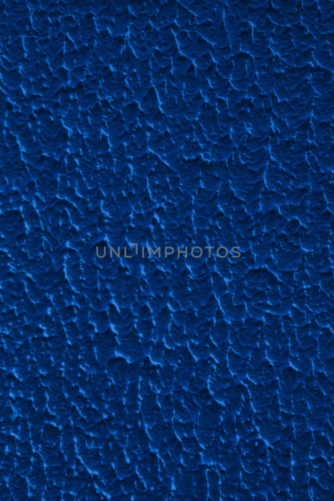 Abstract background of blue rough relief plaster on wall.