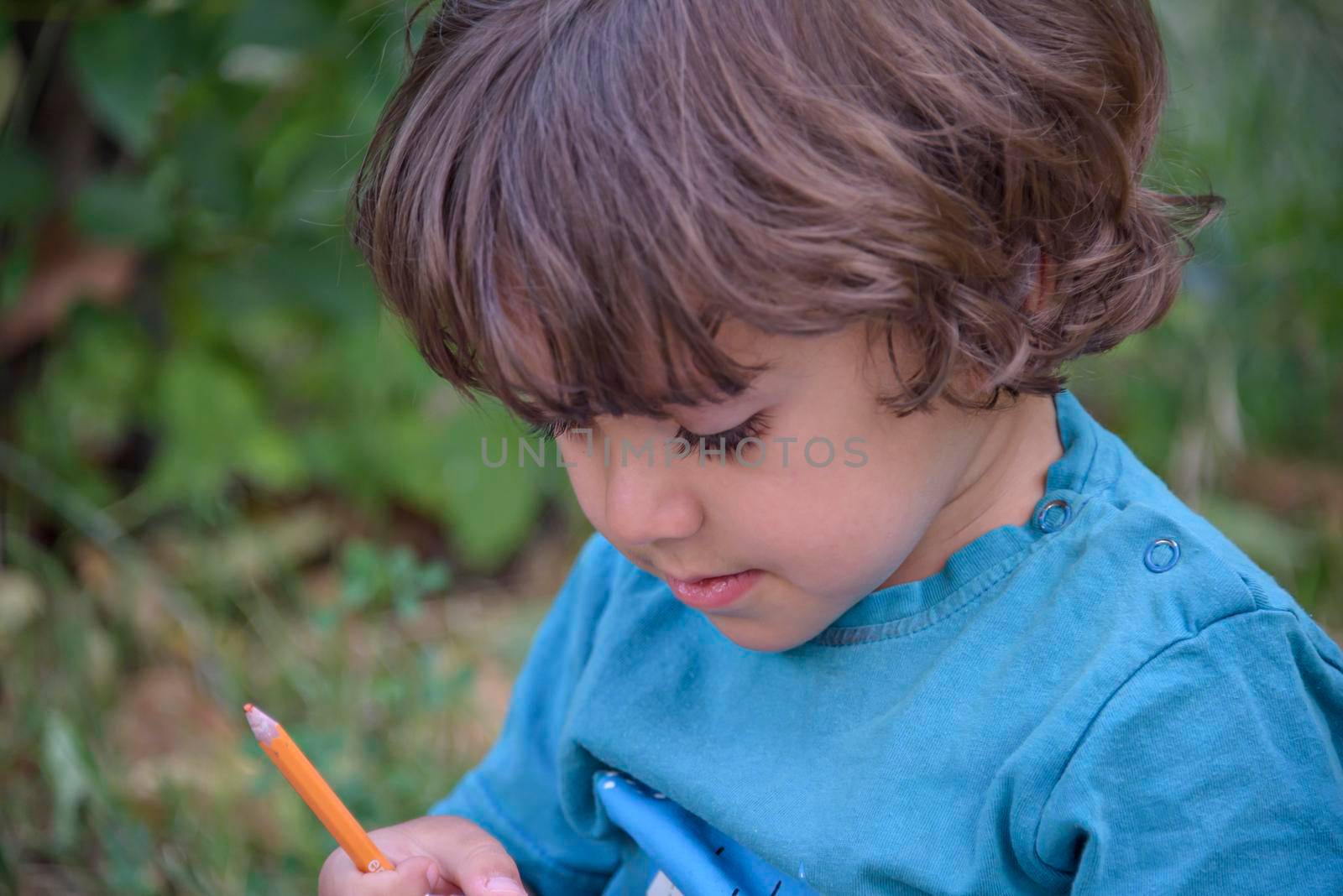 Elementary school age boys love to paint in parks. Boys are drawing pictures as an outdoor hobby. Concept of education outside of school