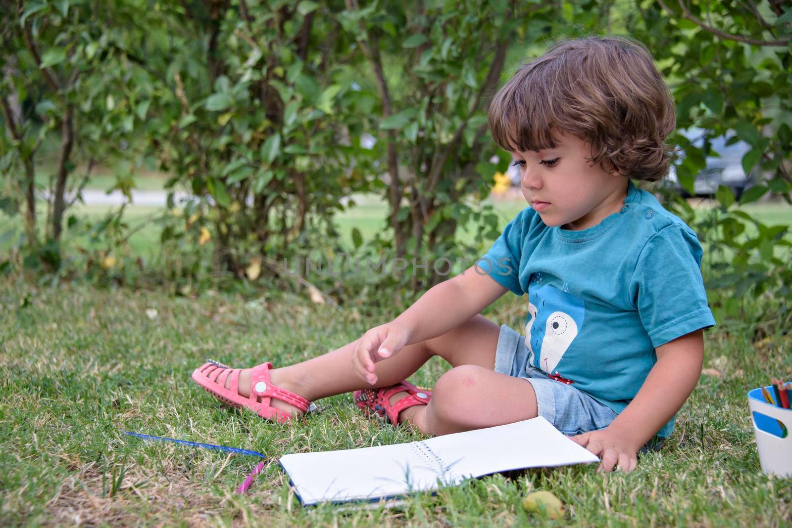 Elementary school age boys love to paint in parks. Boys are drawing pictures as an outdoor hobby. Concept of education outside of school