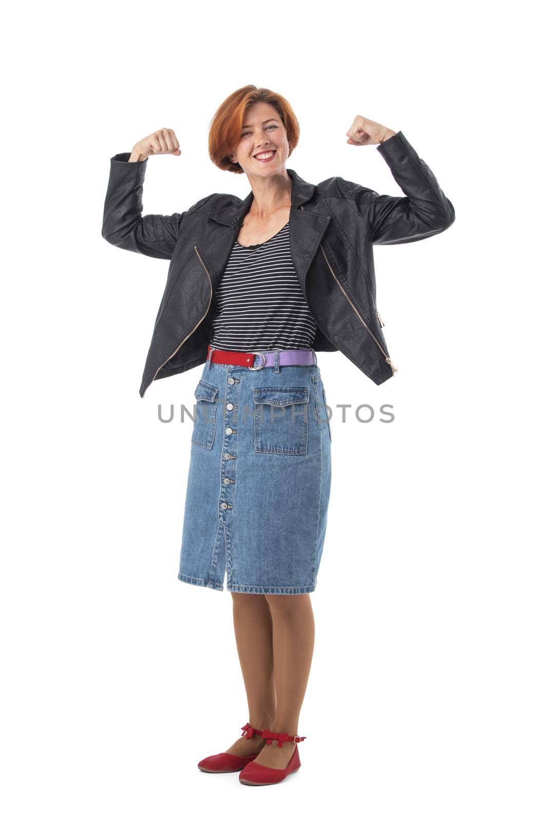 Woman in black leather jacket and skirt shows biceps demonstrates power and muscles on isolated background success strength concept