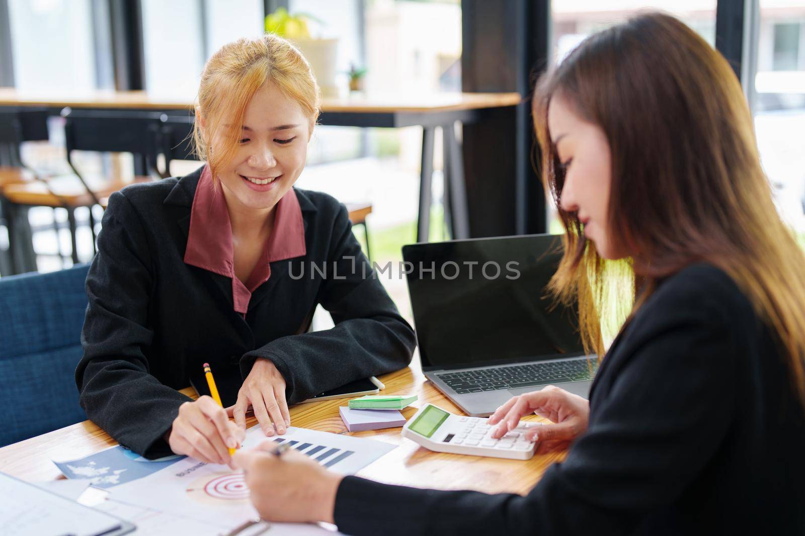 portrait of an Asian businesswoman who is starting to plan a marketing campaign to reach her target audience by Manastrong