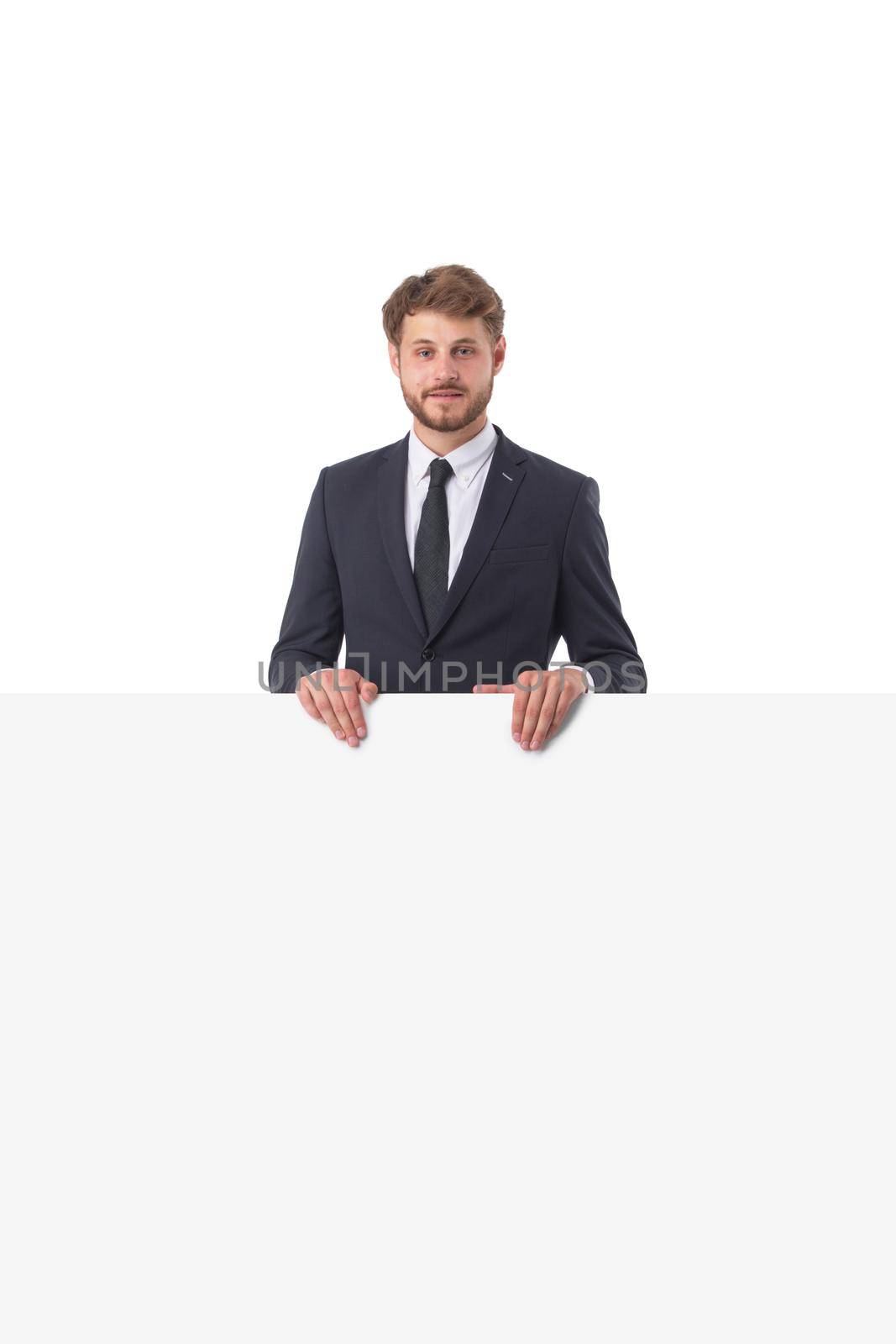Attractive young business man and blank board with copy space for your text isolated on white background
