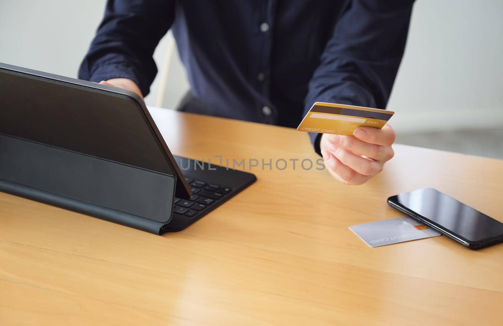 Online payment, Young Women's hands holding credit card and using tablet for online shopping. by Manastrong