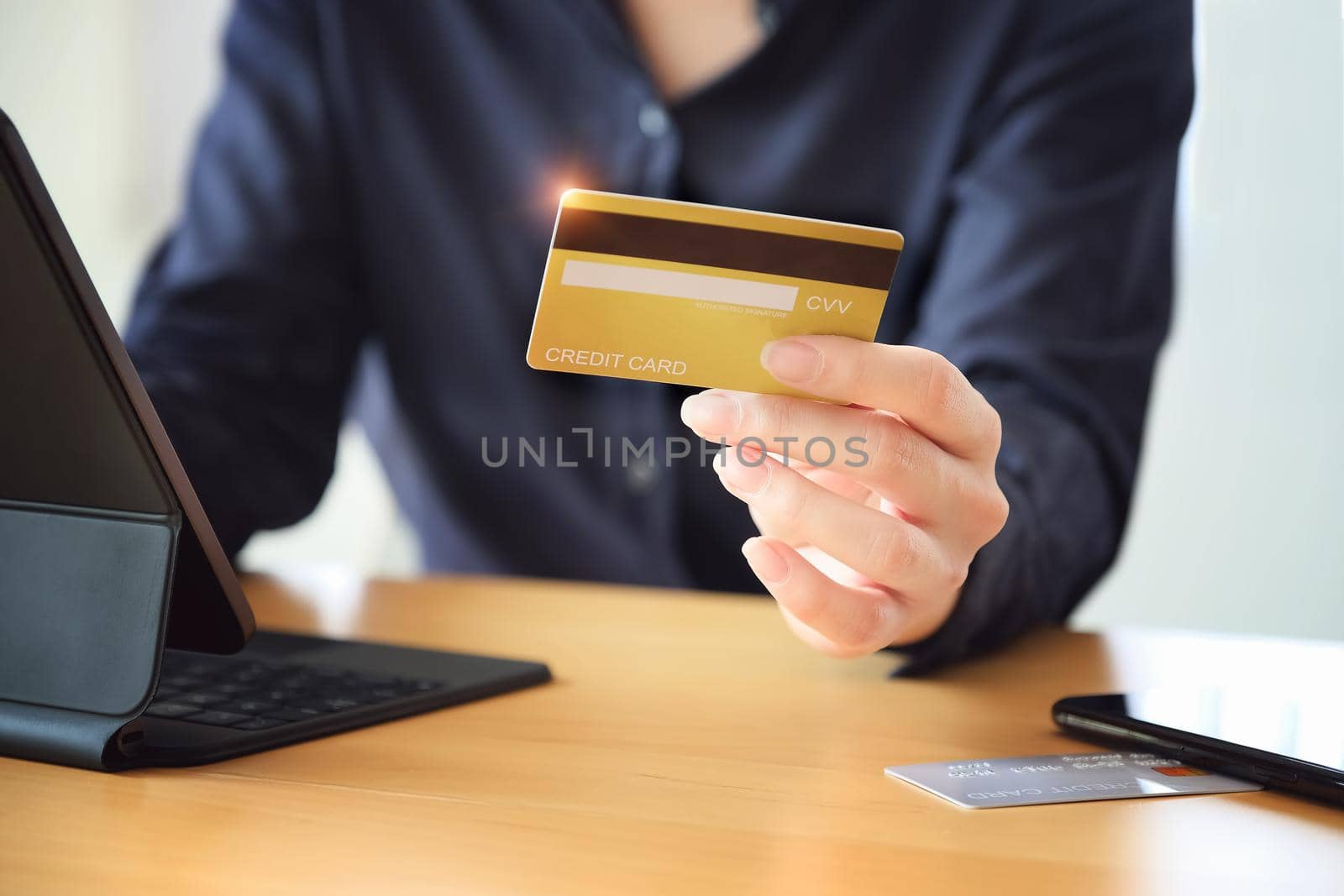 Online payment, Young Women's hands holding credit card and using tablet for online shopping. by Manastrong