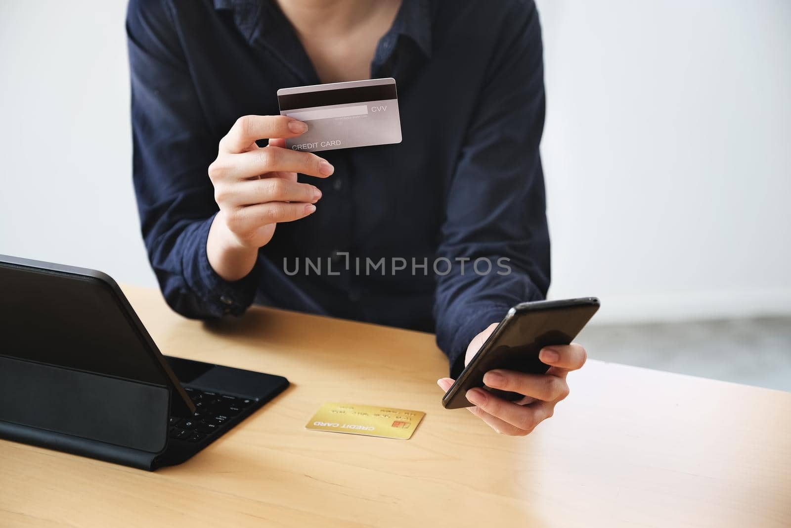 Online payment, Young Women's hands credit card and using smartphone for online shopping by Manastrong