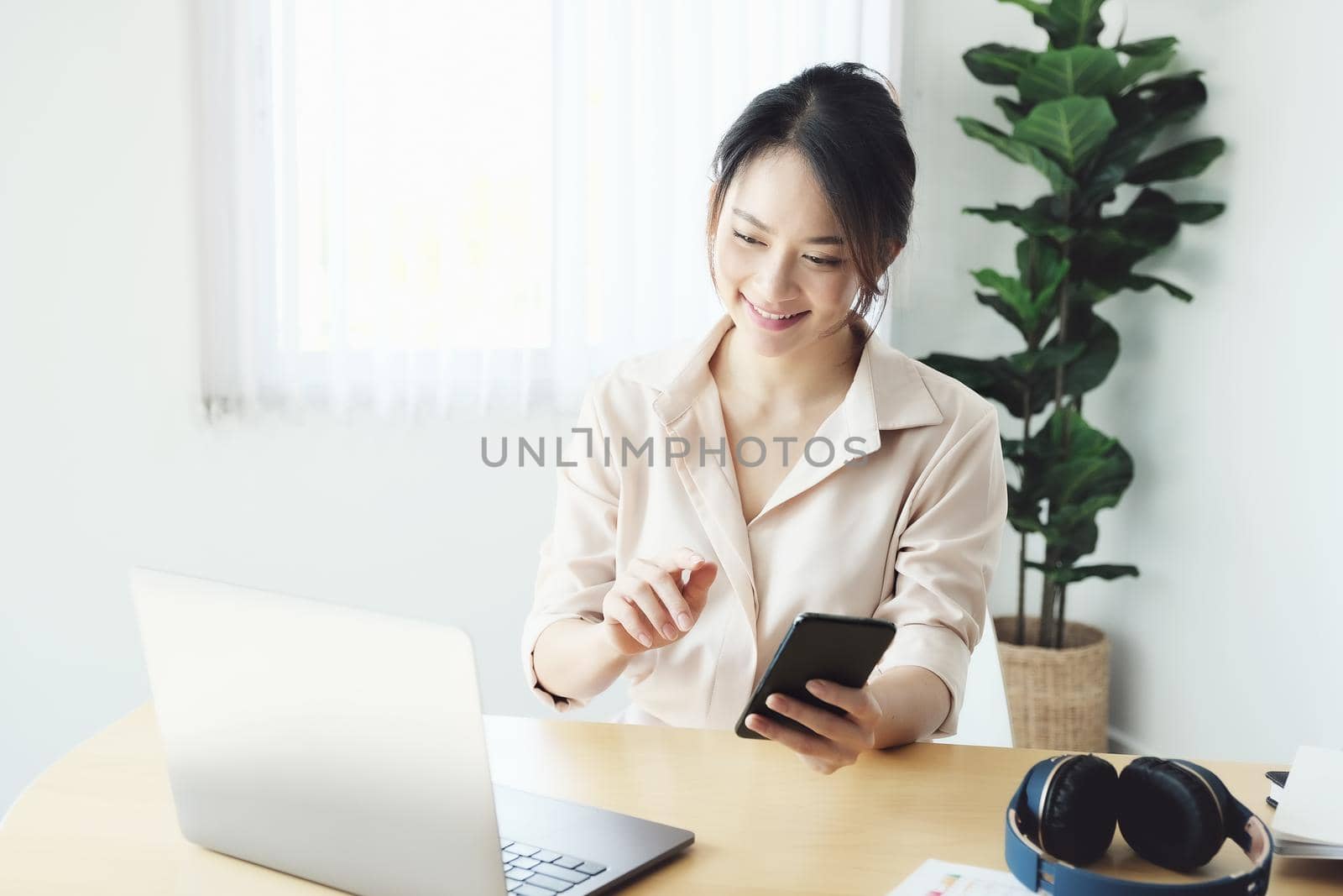 new normal, a businesswoman using computer to work for a company Via the internet on your desk at home. by Manastrong