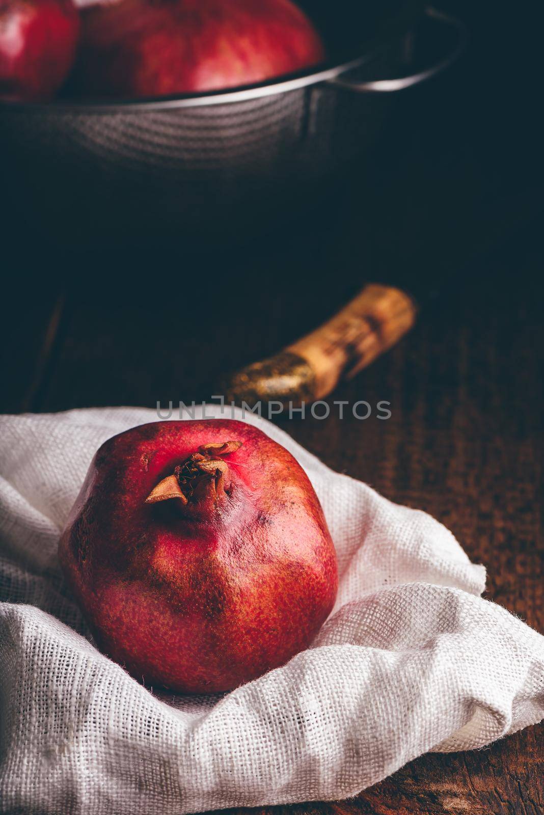 Red and ripe pomegranate fruits in rustic setting