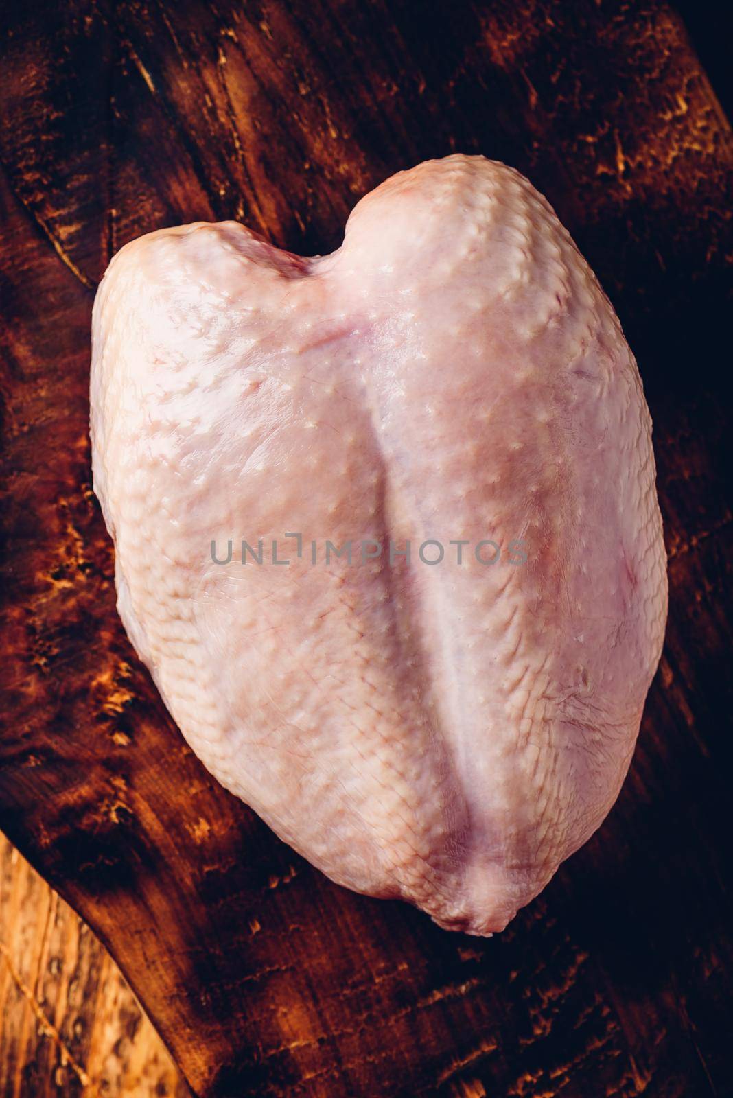 Raw chicken breast on chopping board by Seva_blsv