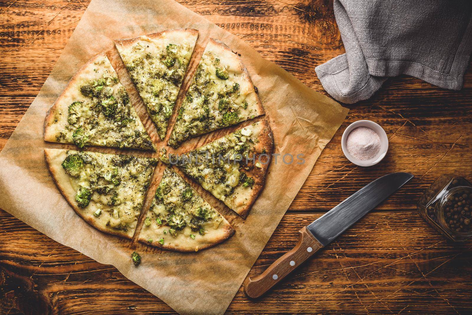 Sliced pizza with broccoli, herbs and parmesan by Seva_blsv