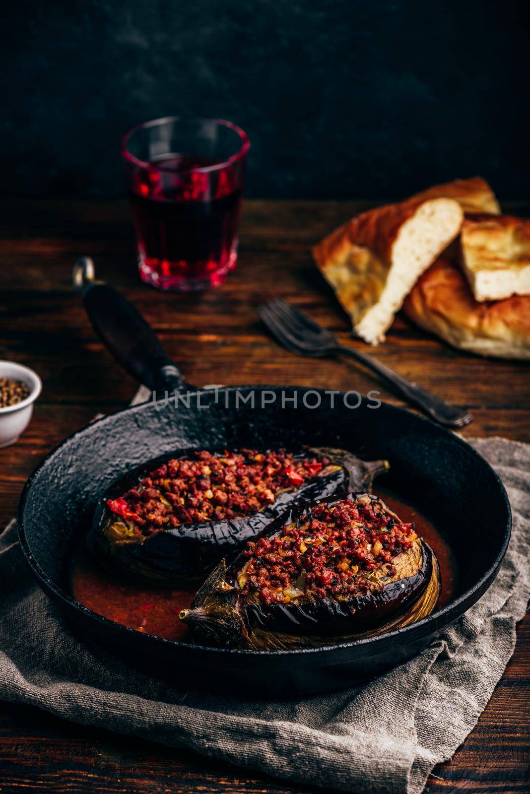 Eggplants stuffed with ground beef, tomatoes and spices in frying pan. Traditional dish Karniyarik of turkish cuisine
