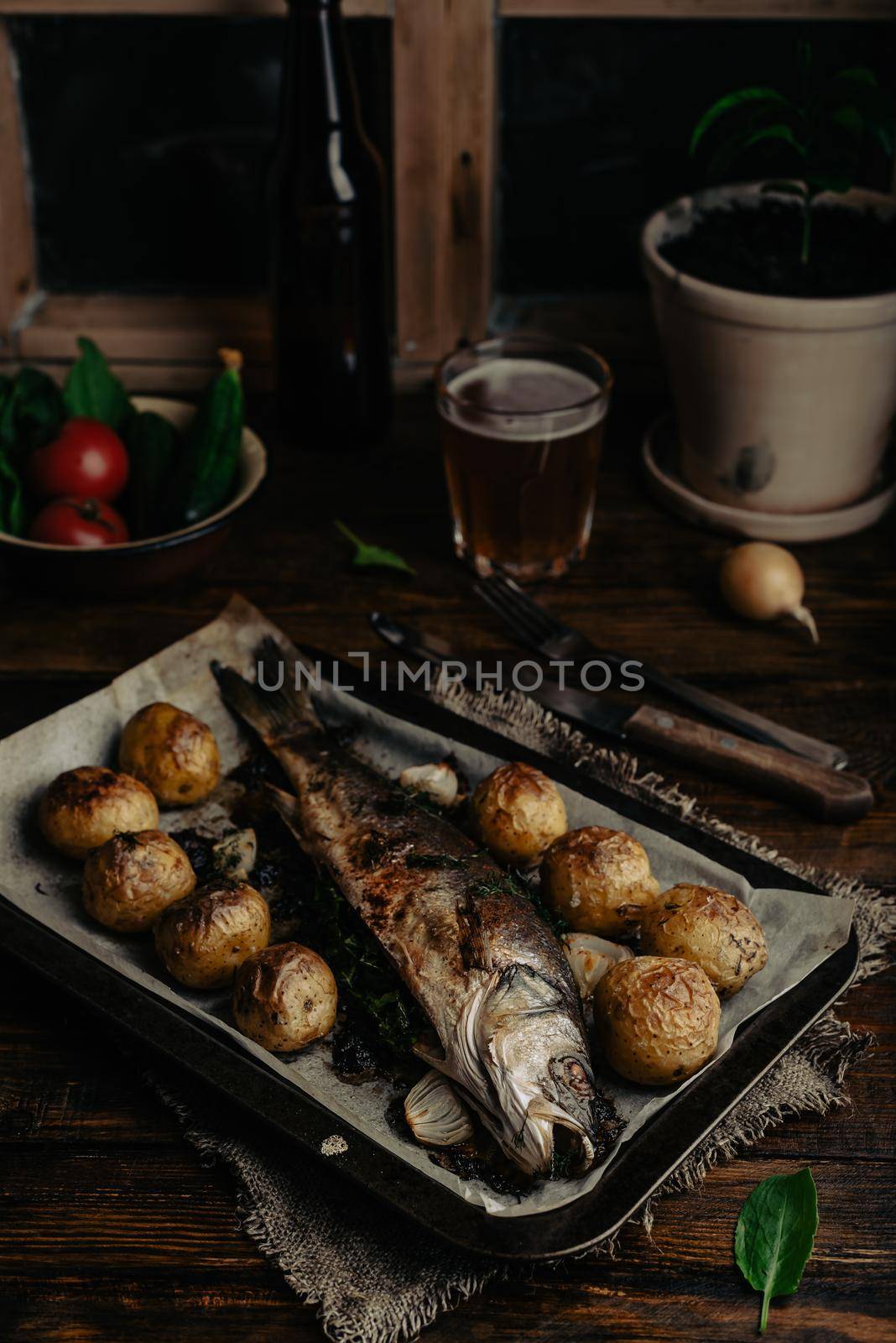 Baked Sea Bass Stuffed with Sorrel and New Potatoes on Baking Tray