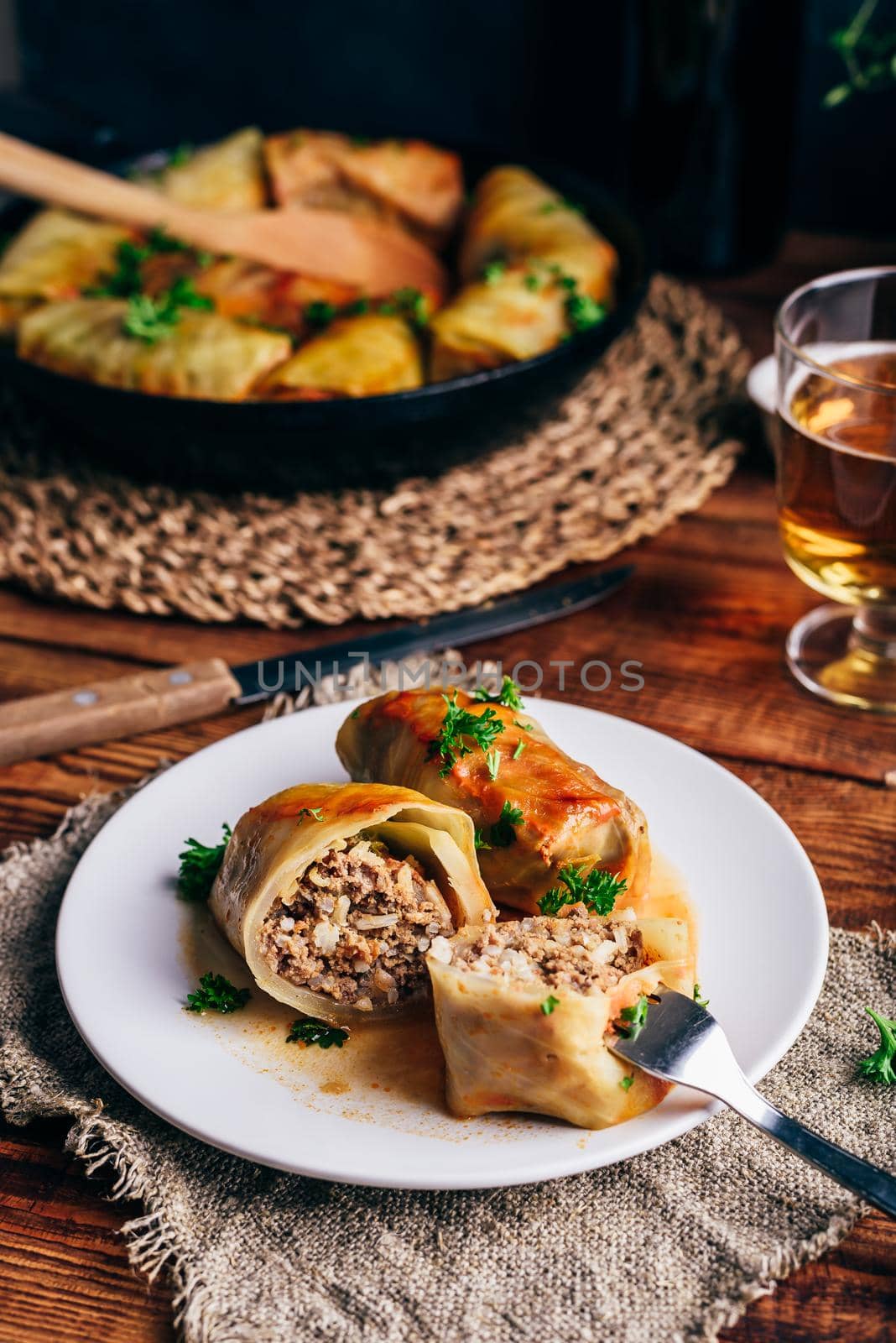 Two Cabbage Rolls Stuffed with Minced Meat and Rice on White Plate Served with Chopped Parsley