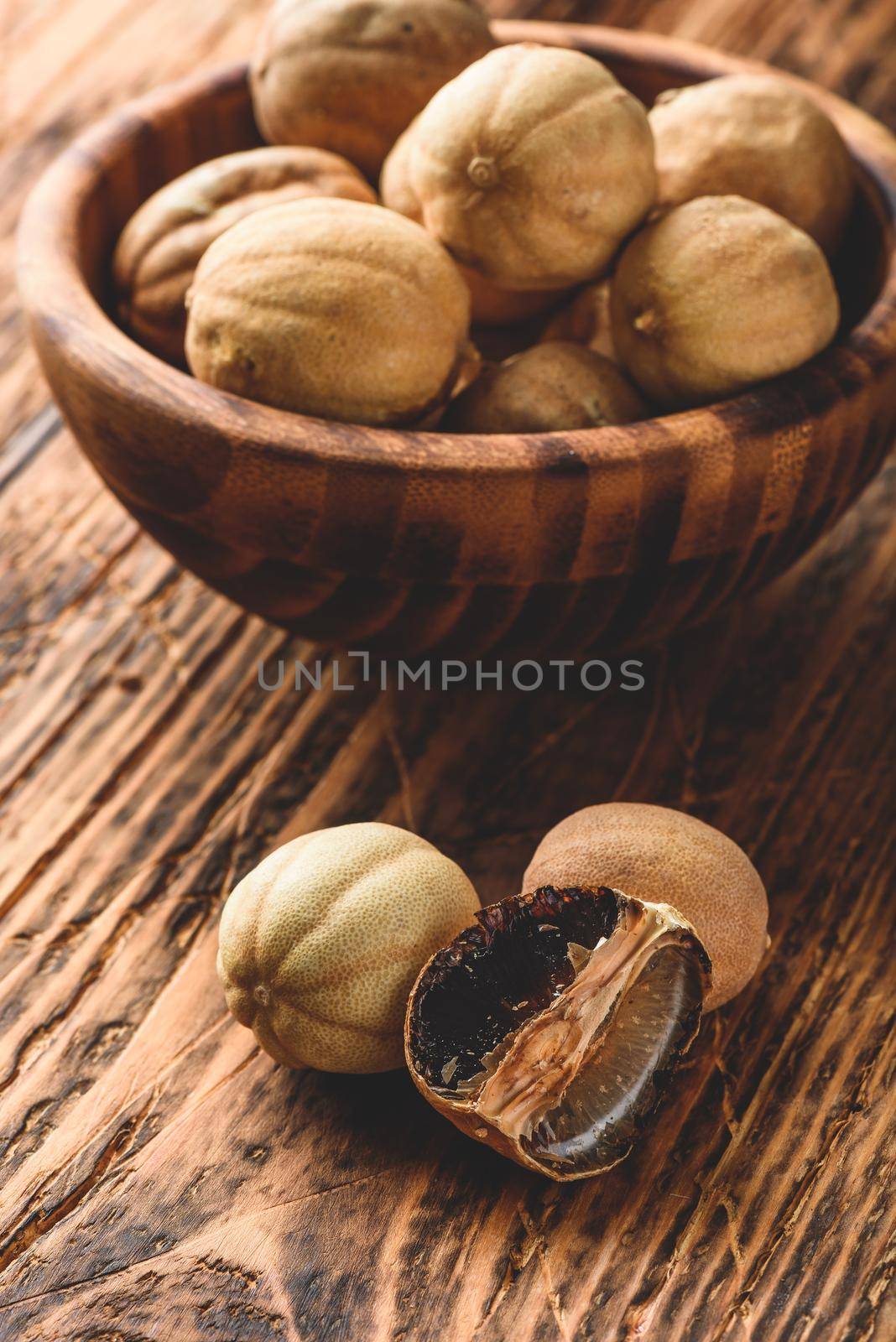 Dried limes on wooden table by Seva_blsv