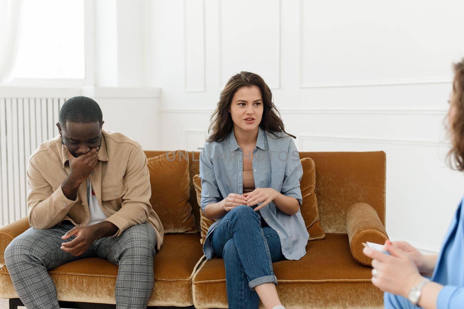 A diverse couple came to a session with a psychologist. Relationship problems, avoiding divorce.