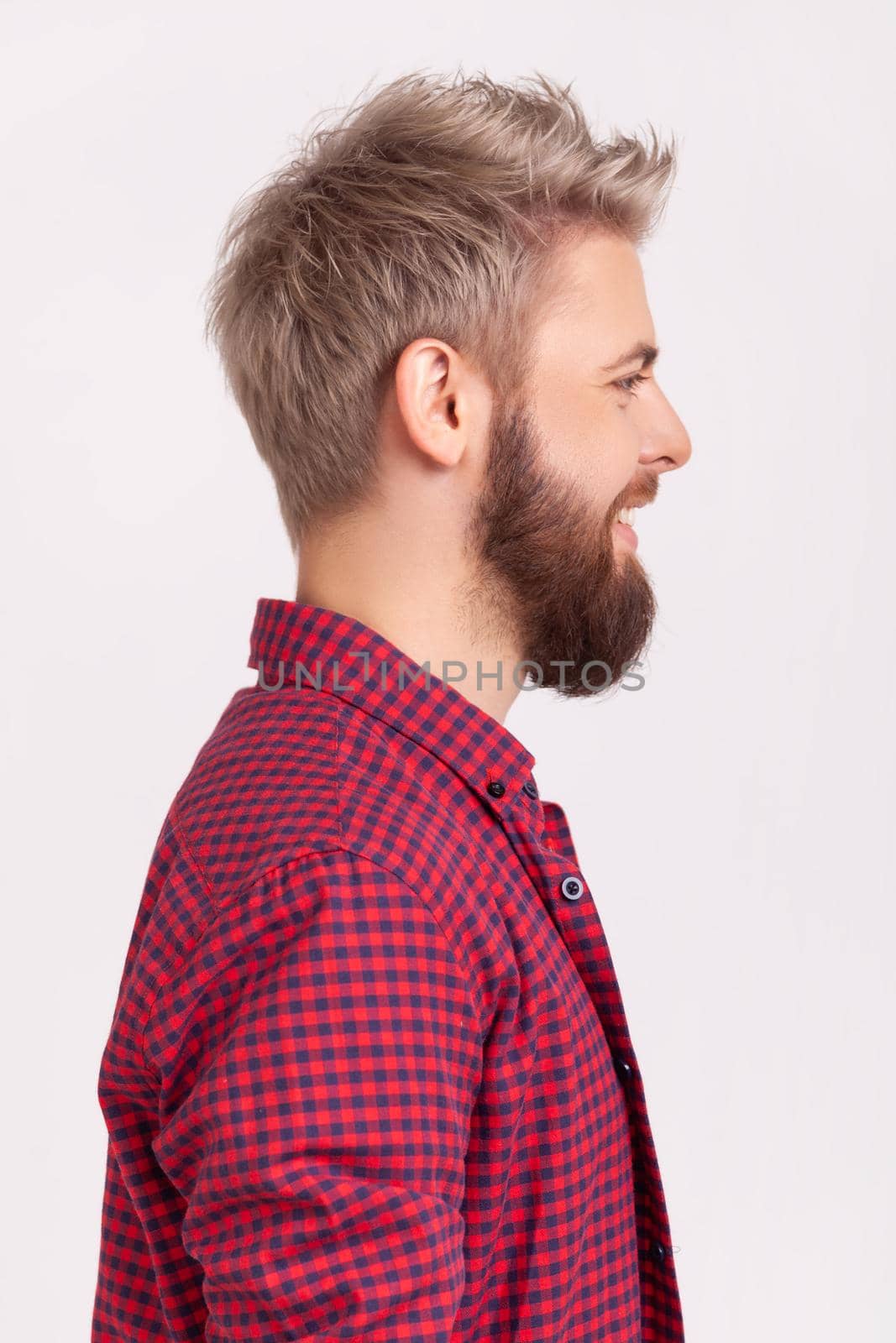 Profile portrait of happy bearded millennial man in red t-shirt sincerely smiling and looking to side, positive mood and optimistic lifestyle by Khosro1