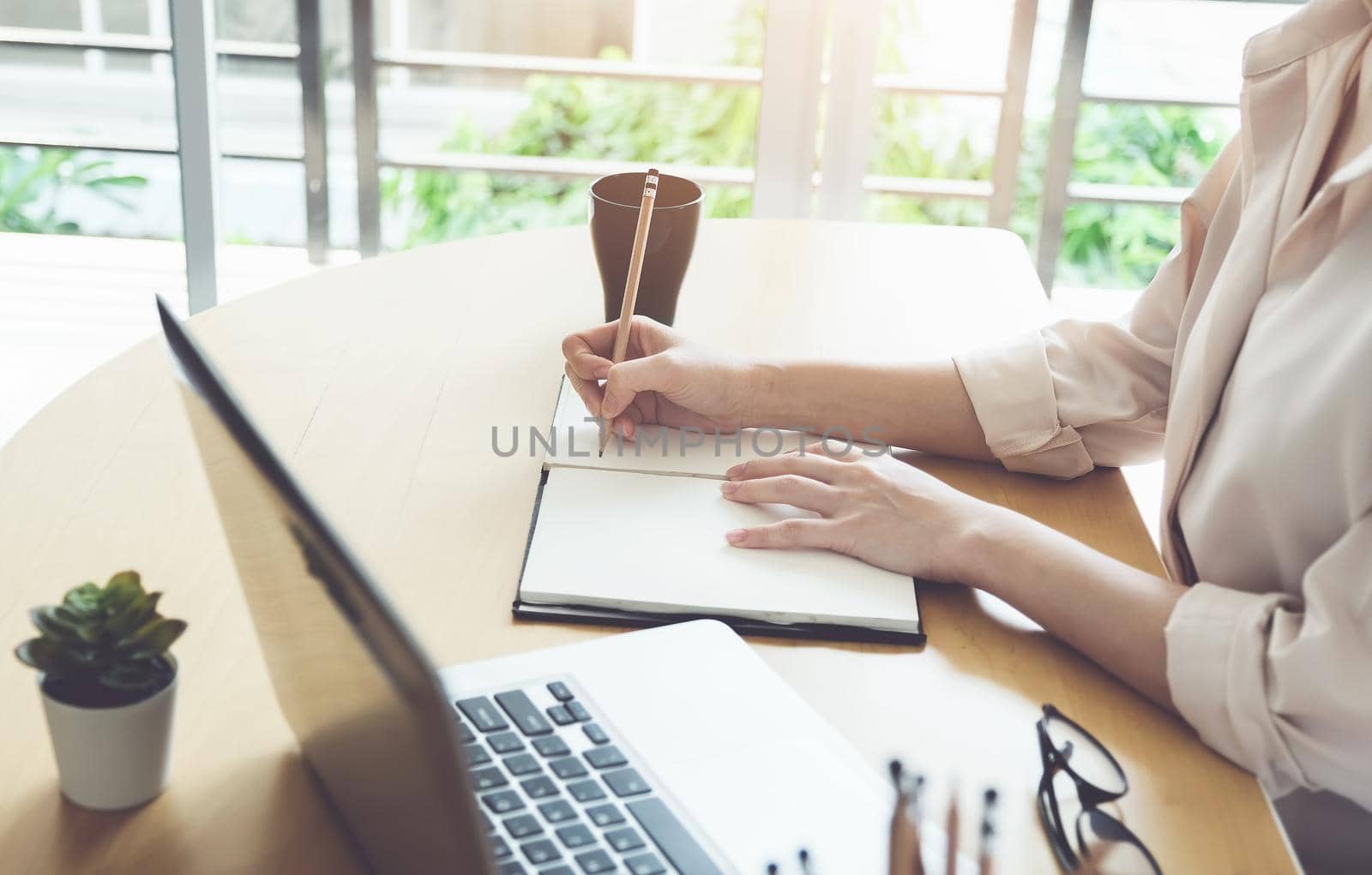 new normal, a businesswoman useing notebook and computer to work for a company Via the internet on your desk at home. vintage effect