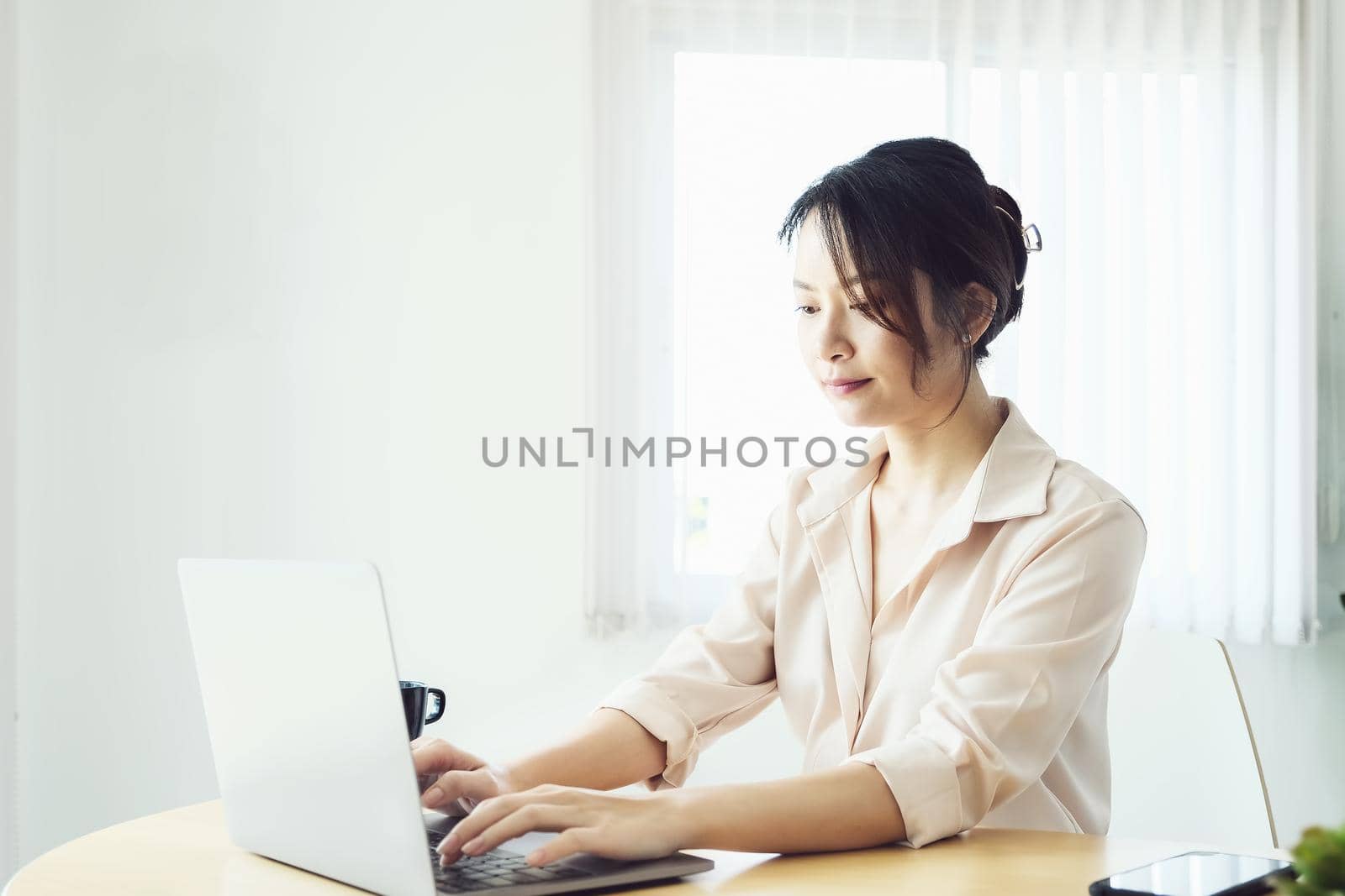 new normal, a businesswoman using computer to work for a company Via the internet on your desk at home.