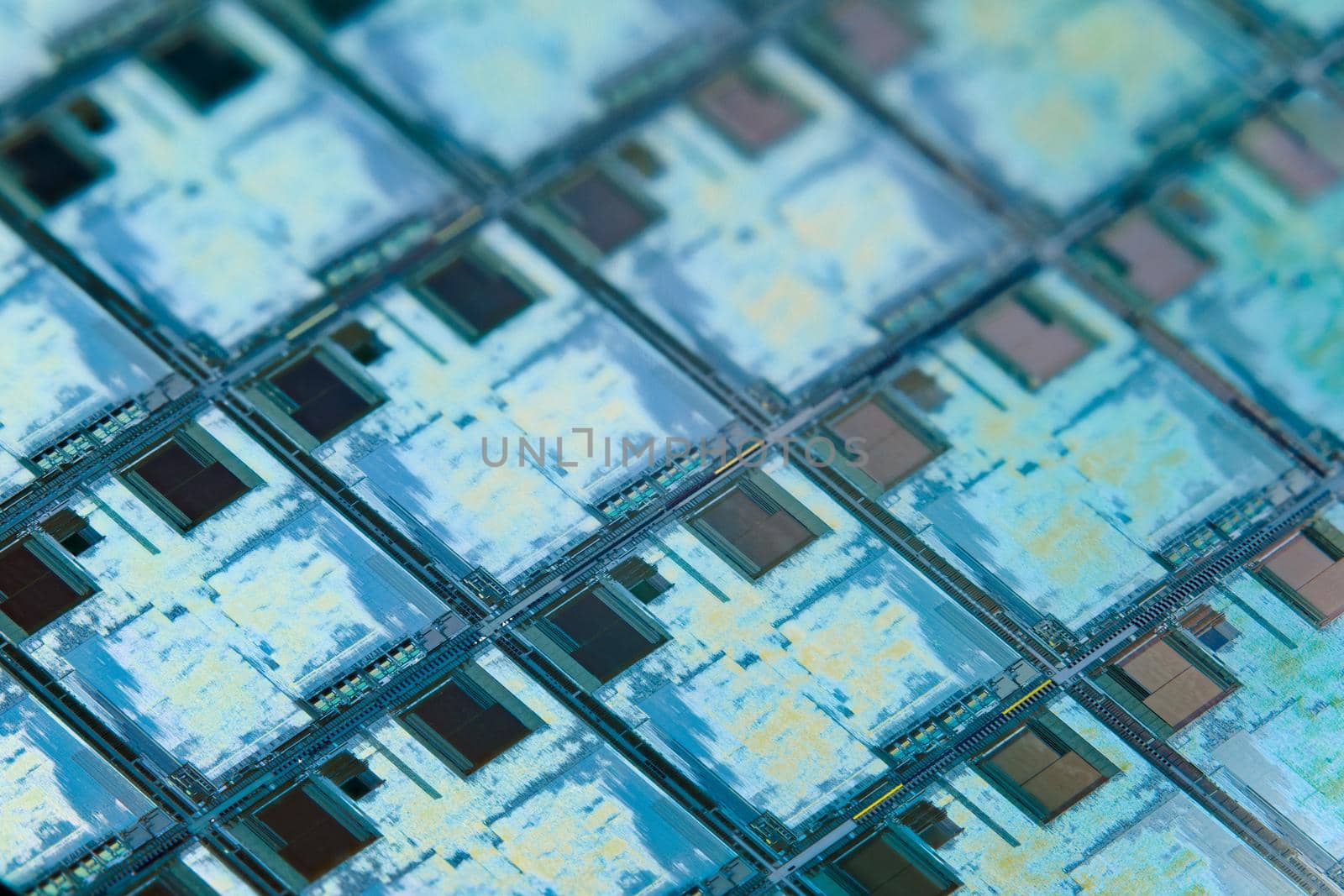 Silicon monocrystalline wafer with microchips after photolithography etching manufacturing used in fabrication of electronic integrated circuits. Full-frame high-tech macro background.