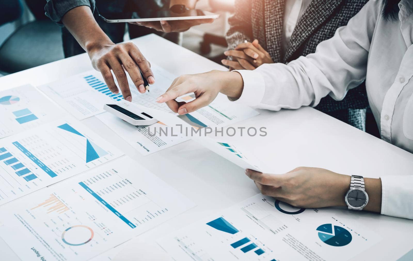 Planning to reduce investment risks, the image of a group of businesspeople working with partners is adjusting marketing strategies to analyze profitable and targeted customer needs at meetings by Manastrong