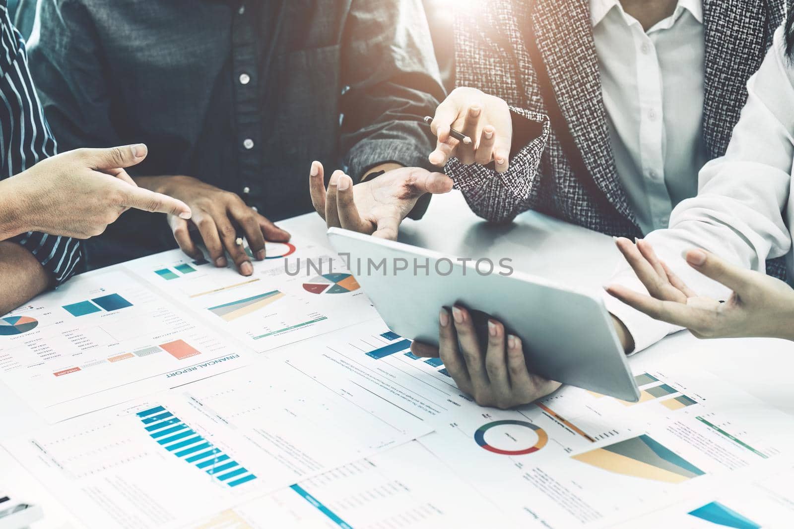 Planning to reduce investment risks, the image of a group of businesspeople working with partners is adjusting marketing strategies to analyze profitable and targeted customer needs at meetings by Manastrong