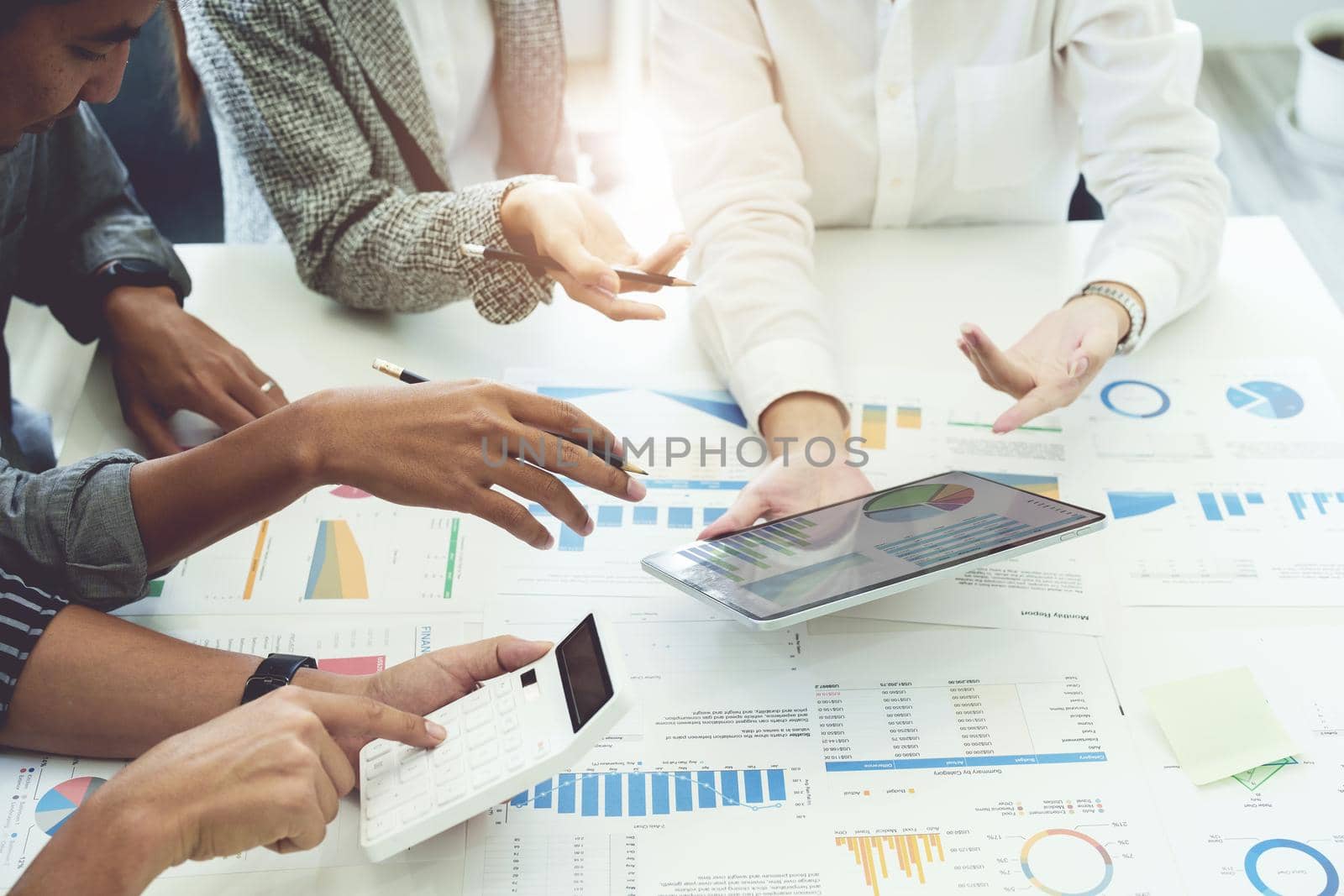 Planning to reduce investment risks, the image of a group of businesspeople working with partners is adjusting marketing strategies to analyze profitable and targeted customer needs at meetings by Manastrong