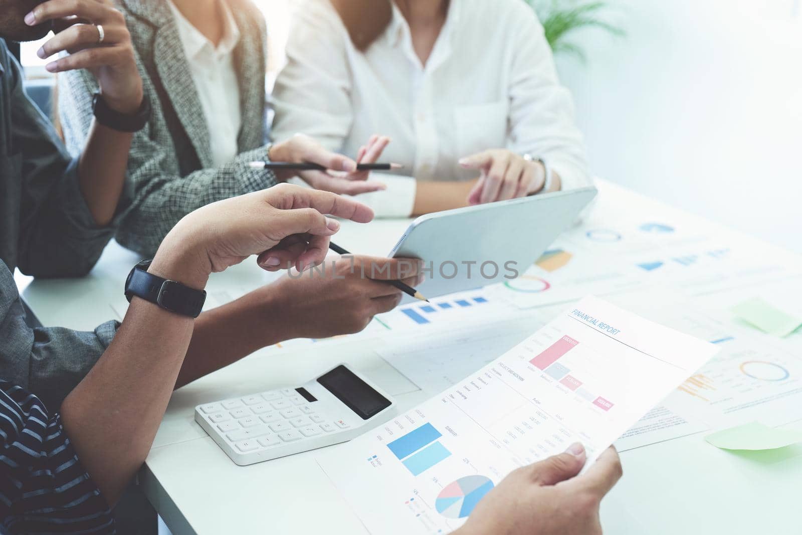 Planning to reduce investment risks, the image of a group of businesspeople working with partners is adjusting marketing strategies to analyze profitable and targeted customer needs at meetings by Manastrong