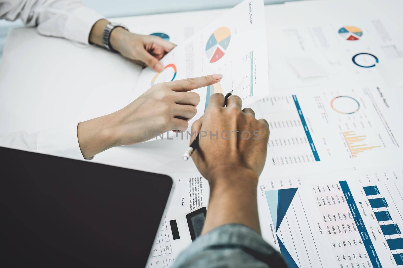 Planning to reduce investment risks, the image of a group of businesspeople working with partners is adjusting marketing strategies to analyze profitable and targeted customer needs at meetings by Manastrong