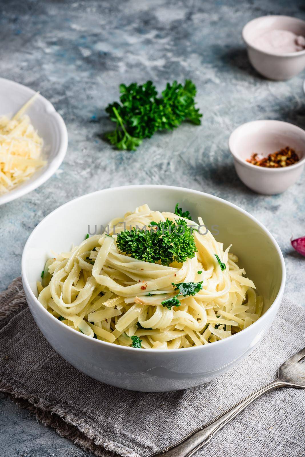 Easy lunch recipe. Linguine pasta with olive oil, garlic, fresh parsley and grated parmesan cheese.