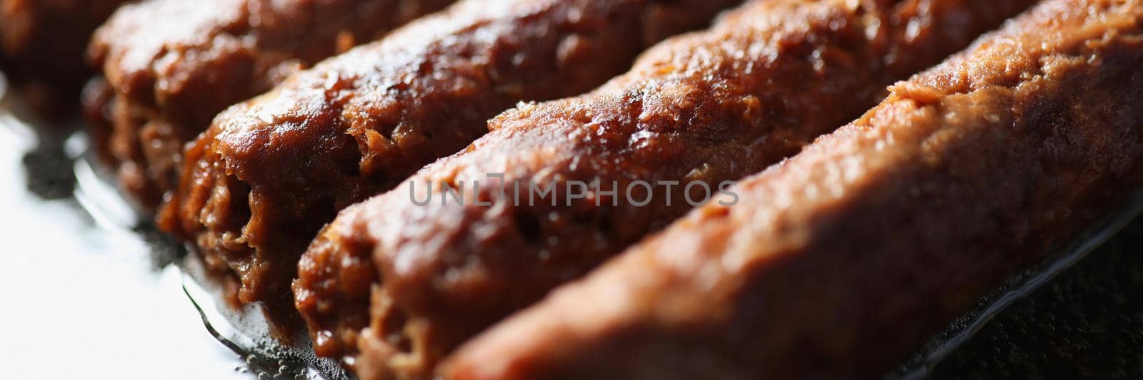 Close-up of set of sweet cannelloni on frying surface, tasty dessert made of dough. Delicious treat for tummy, lunch break. Food, cooking, sweets concept