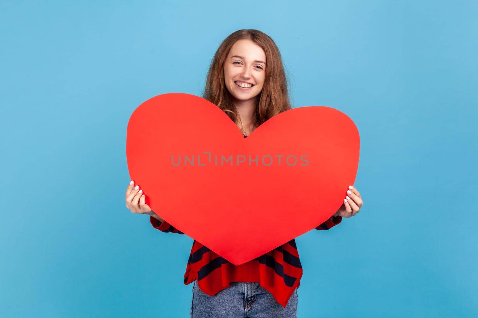 Woman holding big red heart and looking at camera with smile, falling in love, romantic feelings. by Khosro1