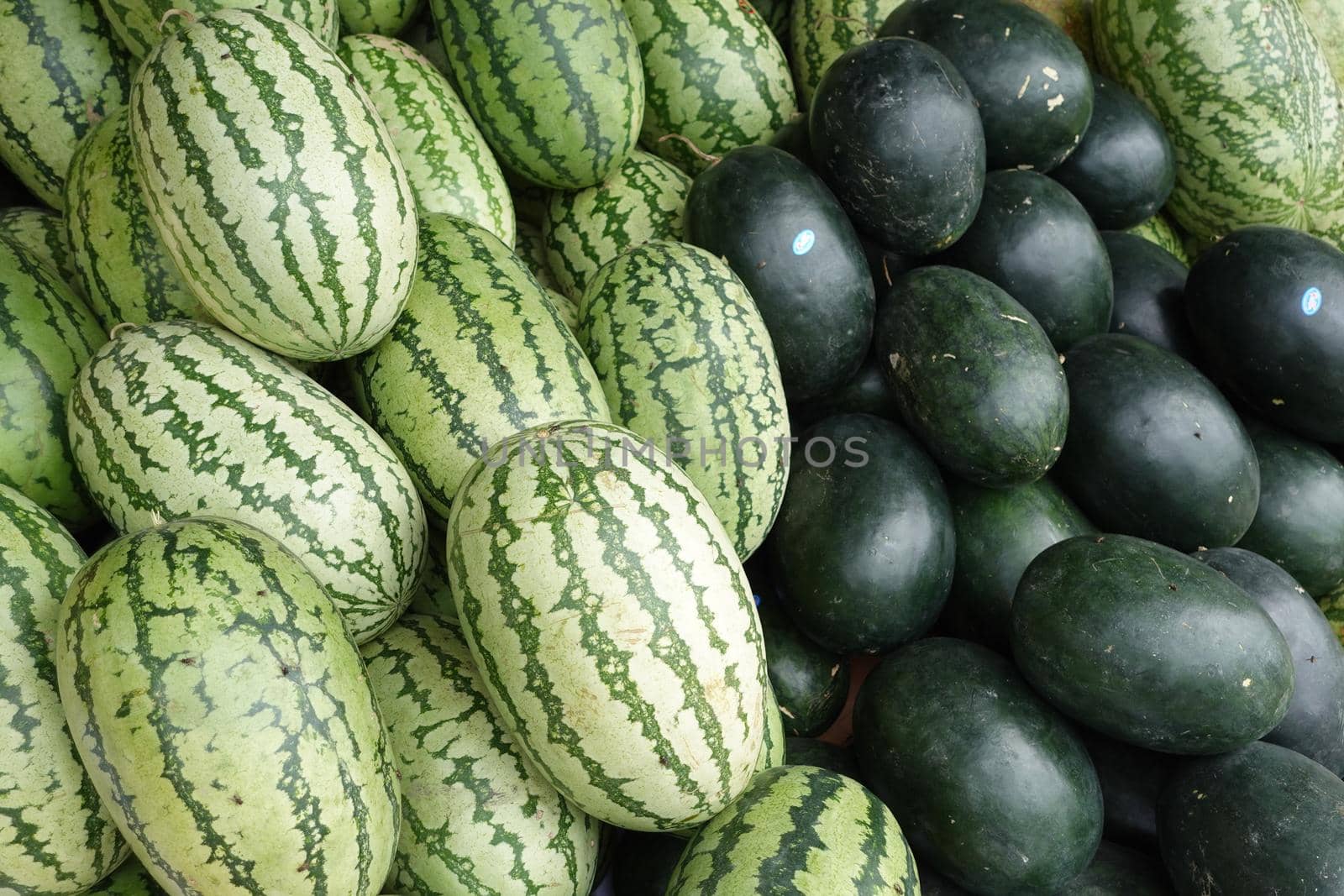 many water melon display for sale at local store ,