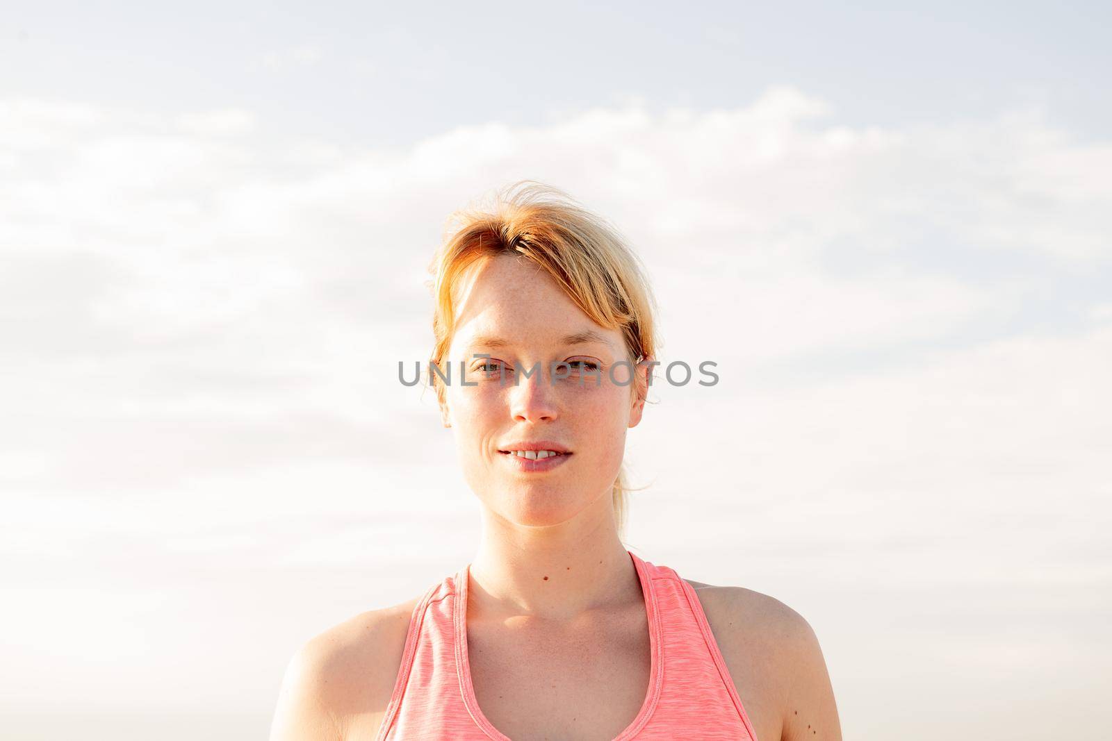 portrait of a beautiful blonde woman with the sky in the background, concept of mental health care and relaxation, copy space for text