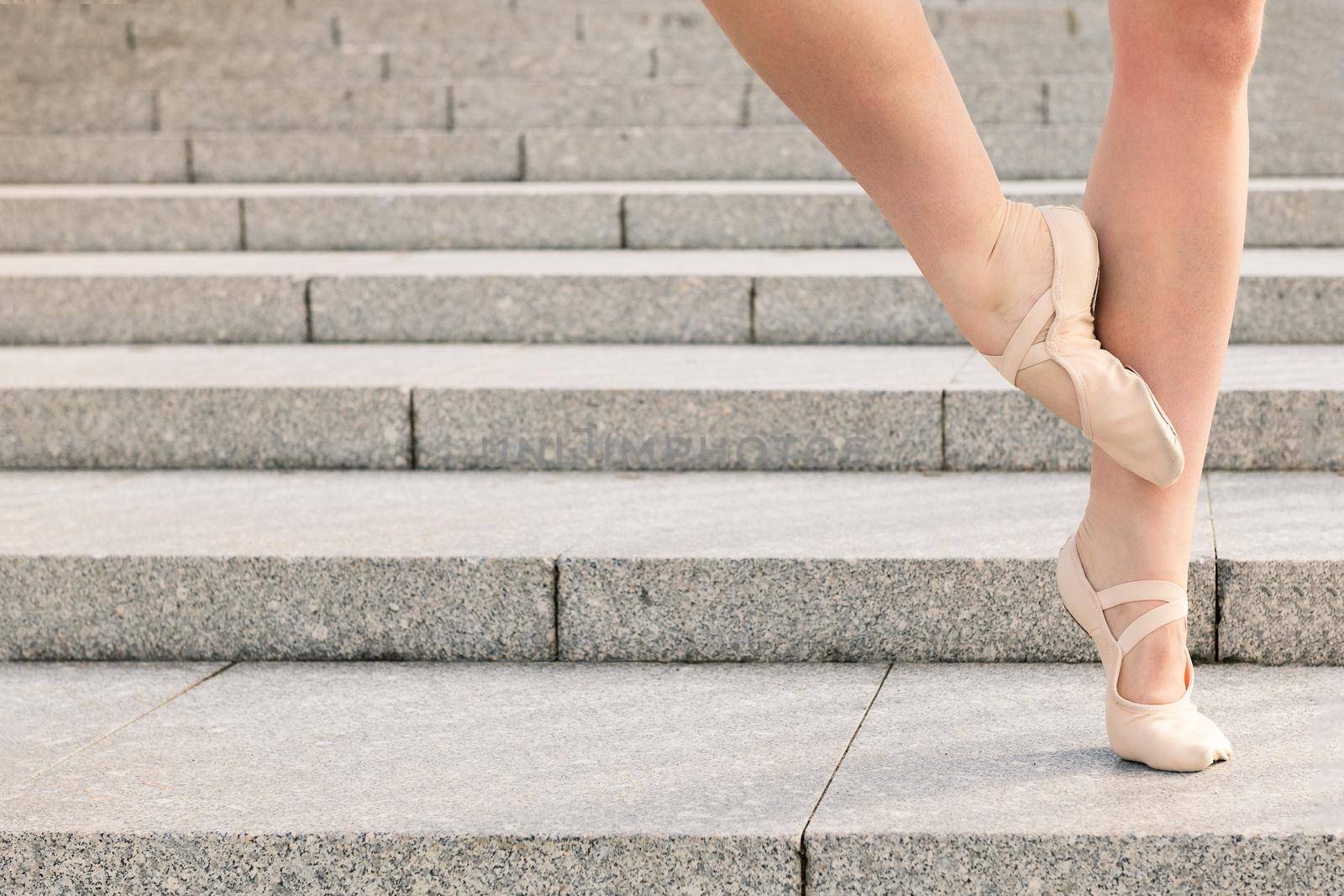 feet of an unrecognizable young ballet dancer on a stone staircase, dance concept and healthy lifestyle, copy space for text