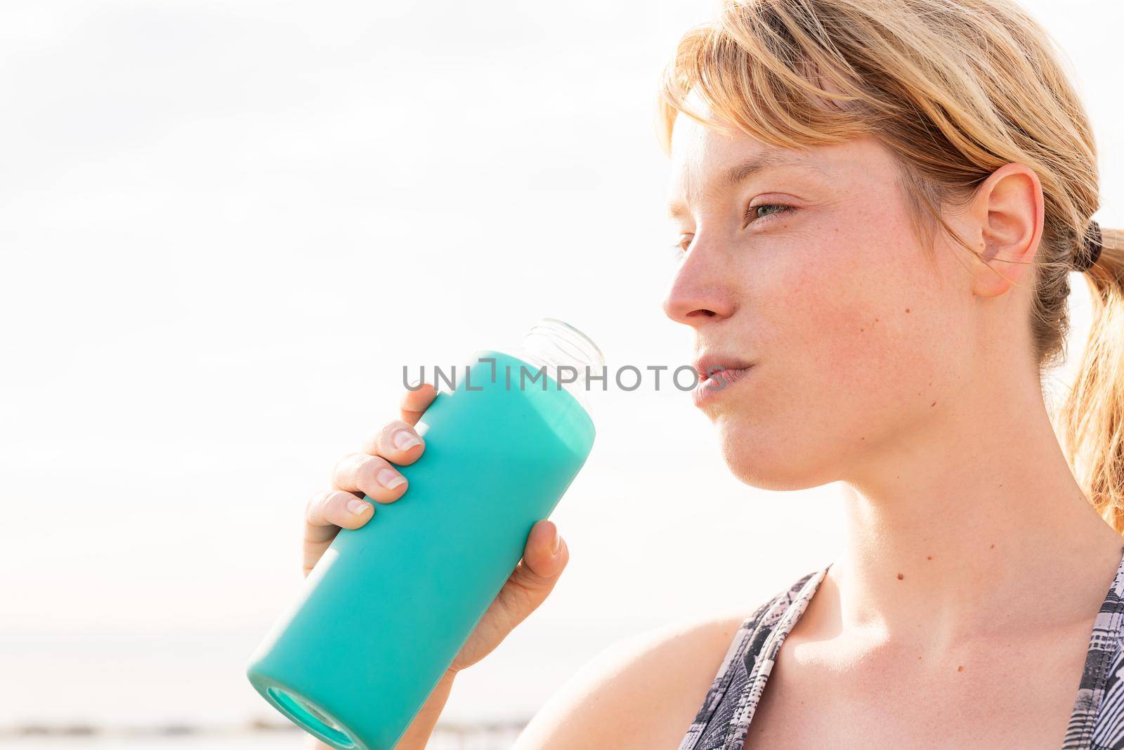 portrait of a sportswoman with a bottle of water, healthy lifestyle and sports concept, copy space for text