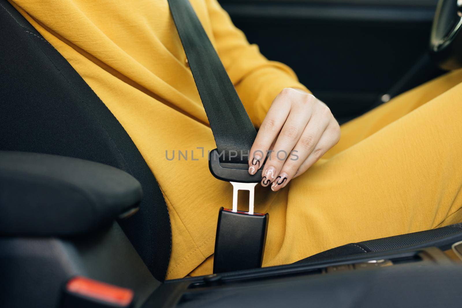 Woman Hand Fastening Car Safety Seat Belt. Protection Road Safety Snap Driving. Driver Fastening Seatbelt In Car. Woman Car Lap Buckling Seat Belt Inside In Vehicle Before Driving by uflypro