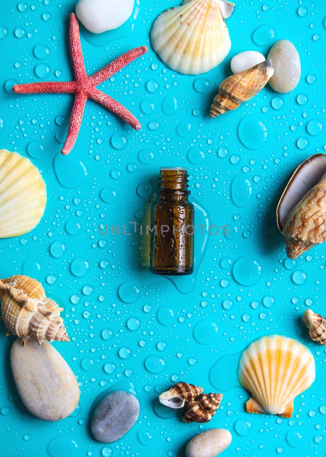 Essential oil on sea background. Selective focus. by yanadjana